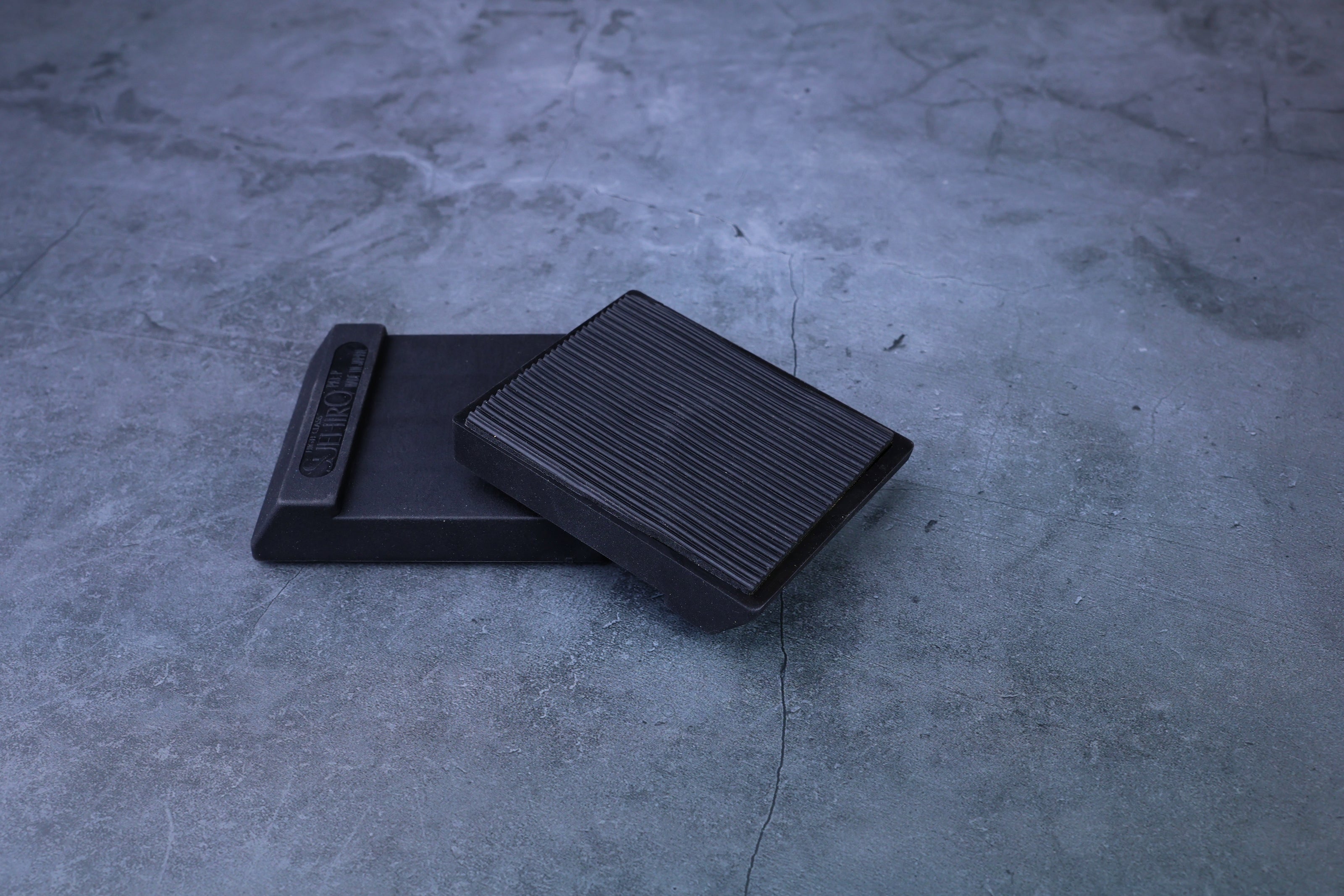 Suehiro rubber whetstone base with ribbed non-slip insert pad resting on top, showing grip texture detail