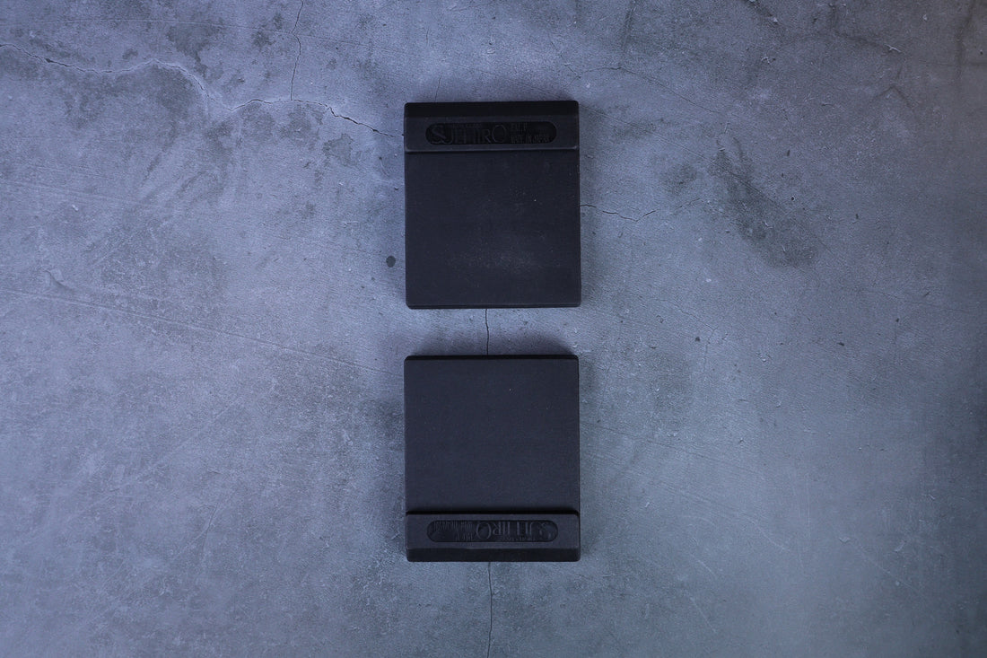 Two Suehiro rubber whetstone bases arranged vertically, straight overhead view showing both from above