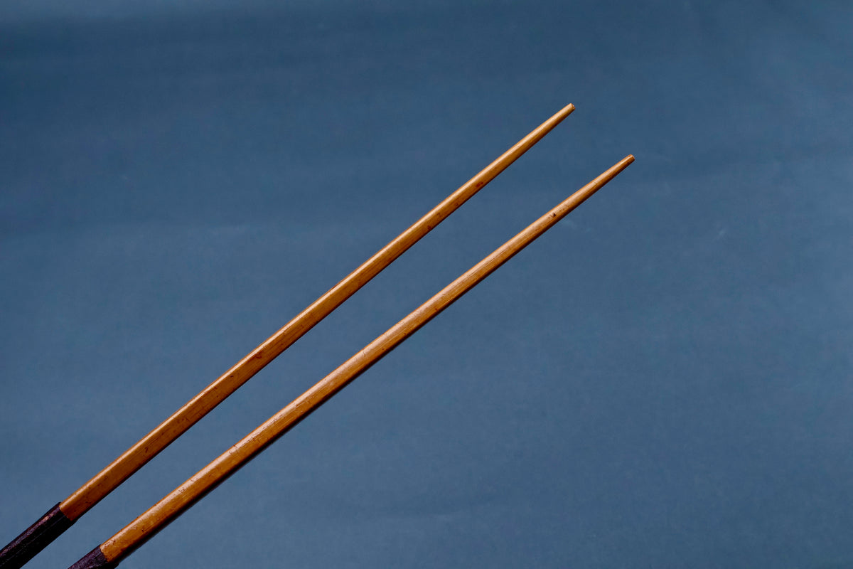 Suri urushi cooking chopsticks 30cm — close-up of tapered bamboo tips against blue background