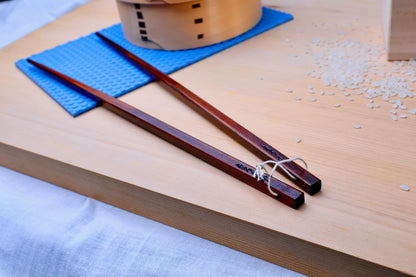 Suri Urushi cooking chopsticks 33cm — laid on hinoki wood surface with rice and wooden ohitsu