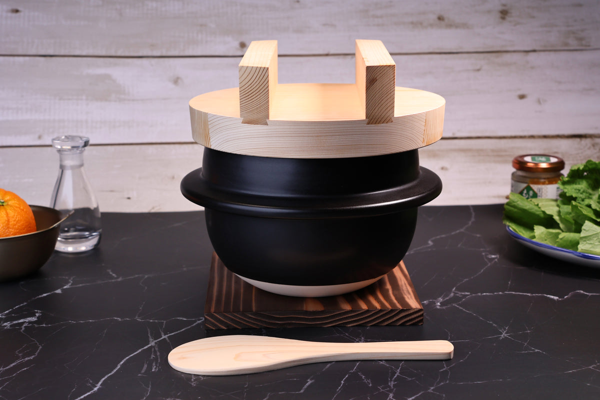 Suzuki Co. Hagama Rice Cooker 3 Cup wooden lid in kitchen setting with food and condiments