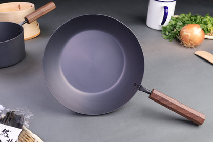 tanabe iron pan circular twenty six cm wood octagonal handle with japanese kitchenware surrounding grey backdrop