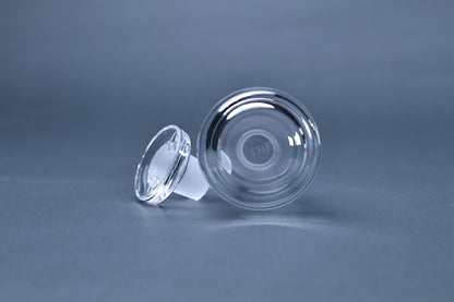 THE soy sauce cruet base showing THE brand engraving and stopper detail on grey background