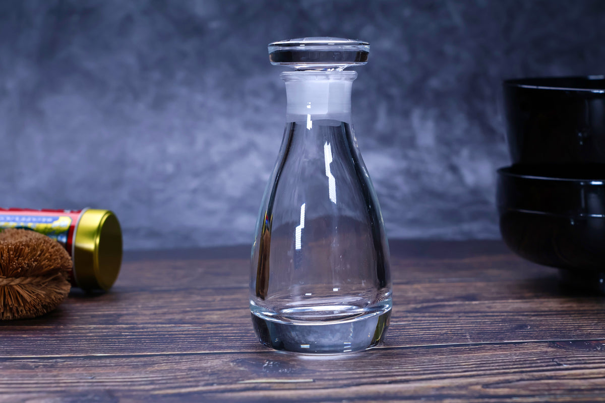 THE soy sauce cruet crystal glass with stopper on dark wood surface styled with Japanese kitchen accessories