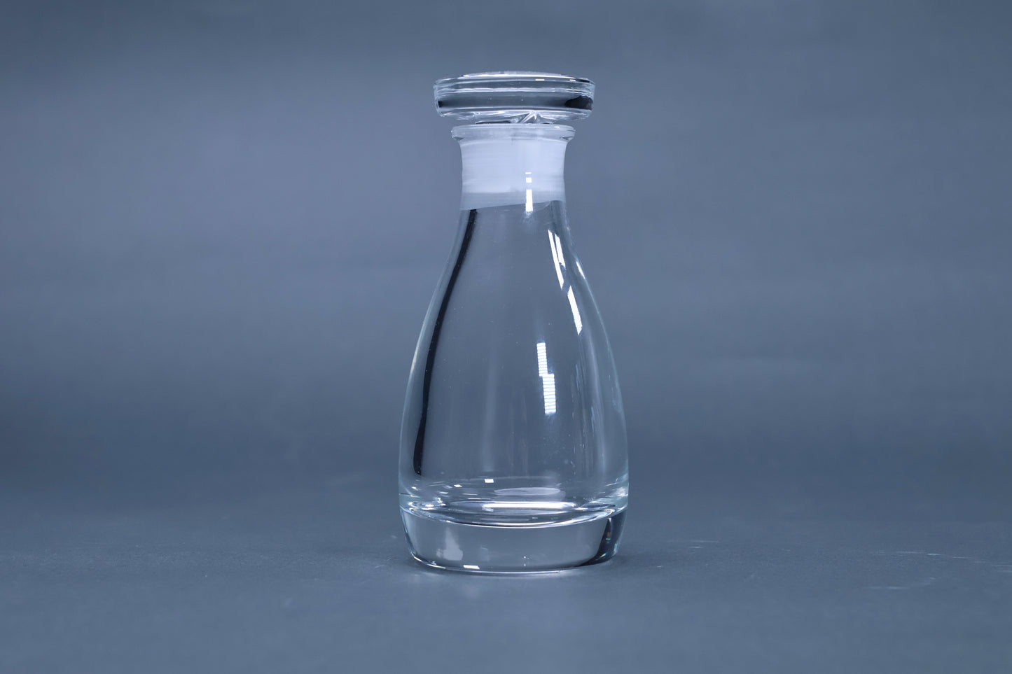 THE soy sauce cruet crystal glass full profile view with stopper on grey background