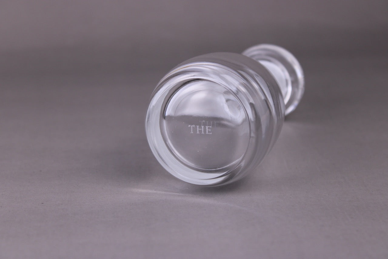 the brand logo shown on bottom of soy sauce cruet crystal with grey background