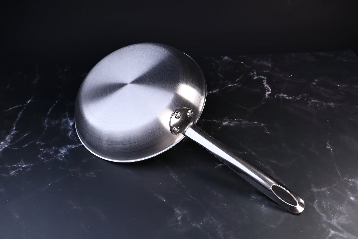 Torino stainless clad frying pan 24cm — exterior base showing clad construction and riveted handle