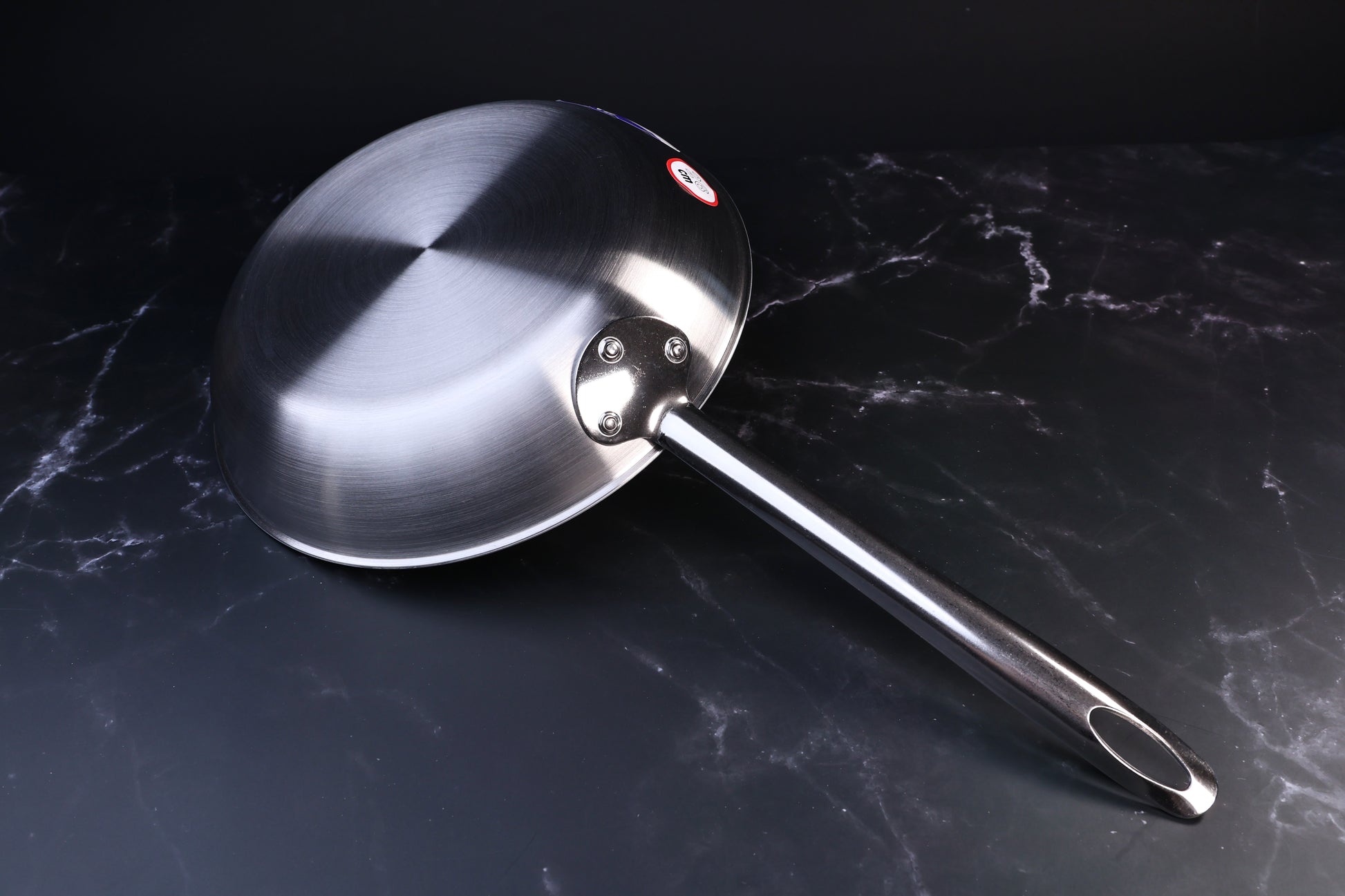 Torino stainless clad frying pan 26cm — exterior base, riveted handle attachment, and brand label
