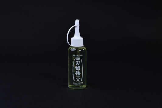 Tsubaki oil for knives and iron pans 100ml — full upright view of bottle, label, and precision applicator tip