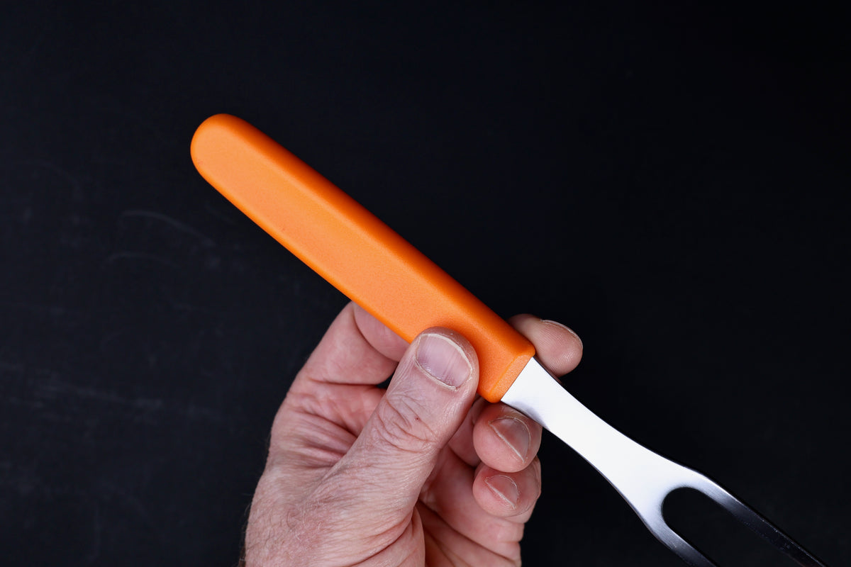 Victorinox Swiss Classic carving fork — orange handle shape and bolster detail held in hand
