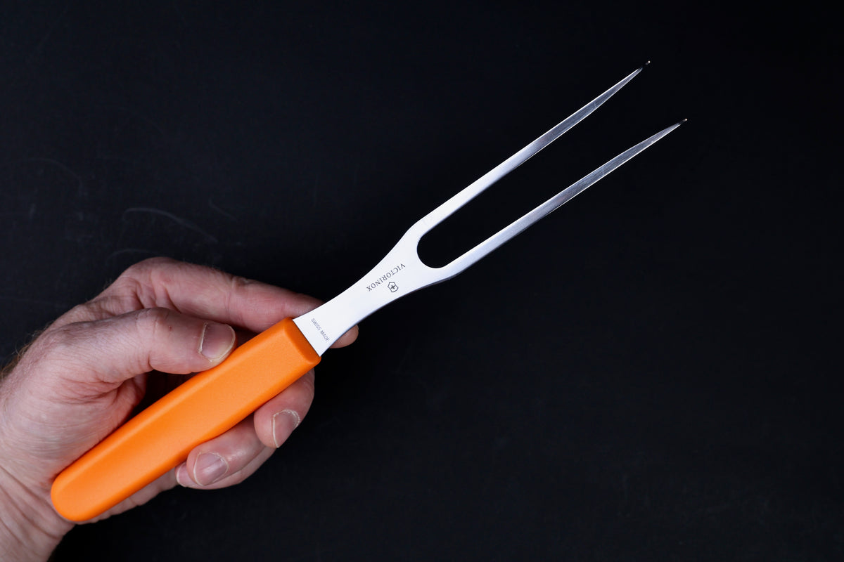Victorinox Swiss Classic carving fork — tine length, Swiss Made stamp, and orange handle held in hand