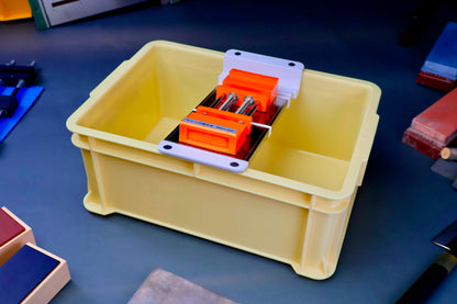 tall yellow knife sharpening box rectangular shaped with suehiro multi sliding rack white and silver with orange rubber whetstone holder surrounded by knife sharpening accessories on dark blue grey surface