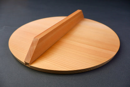closeup shot of yellowish gold colored wooden drop lid grey background
