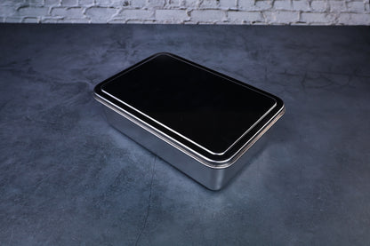 Yakumi 2-compartment condiment pan closed with black lid, full profile angled view