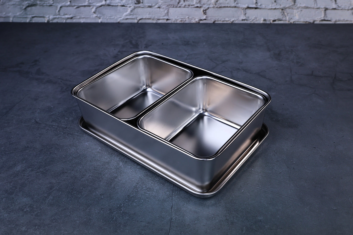 Yakumi 2-compartment condiment pan open, showing both stainless steel inserts, angled overhead view