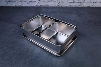 Yakumi 2-compartment condiment pan open, showing both stainless steel inserts, angled overhead view