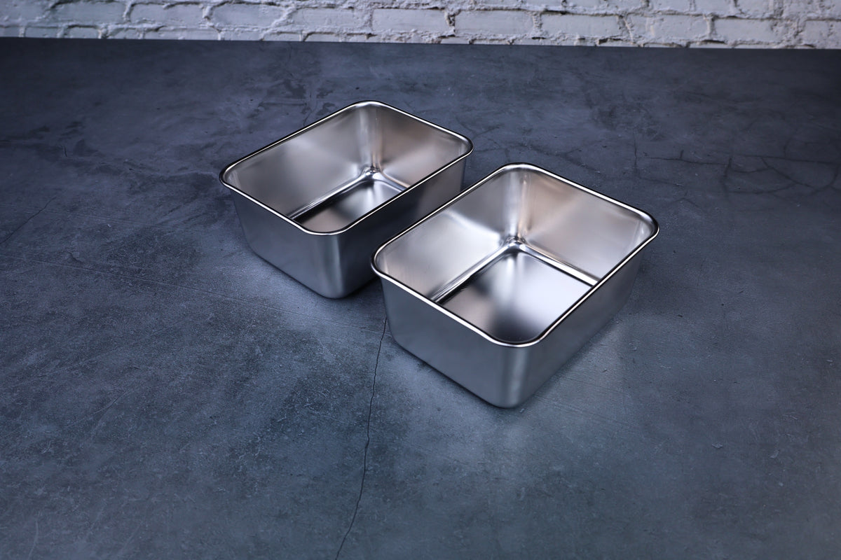 Yakumi 2-compartment condiment pan — two removable stainless steel inserts displayed side by side