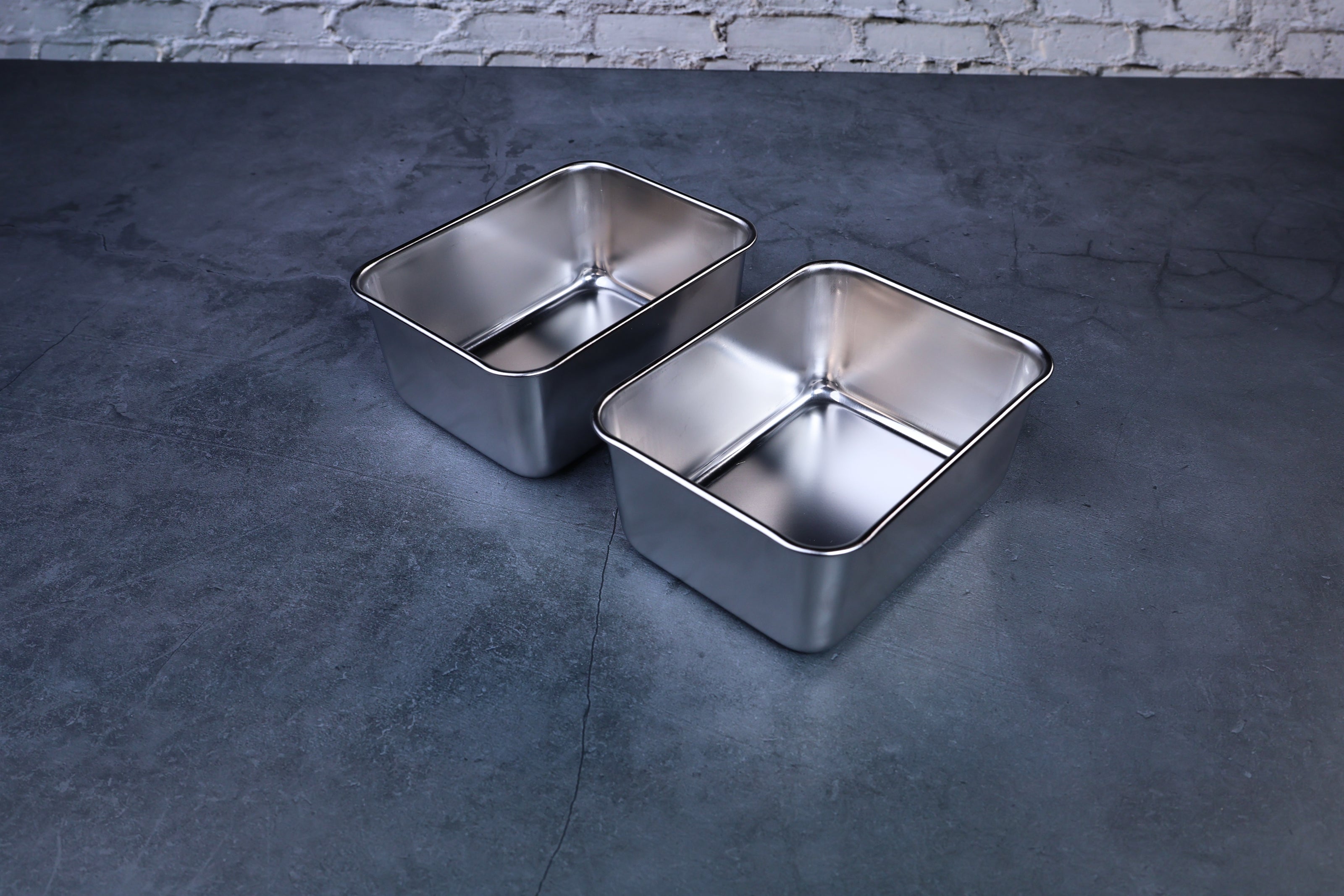 Yakumi 2-compartment condiment pan — two removable stainless steel inserts displayed side by side