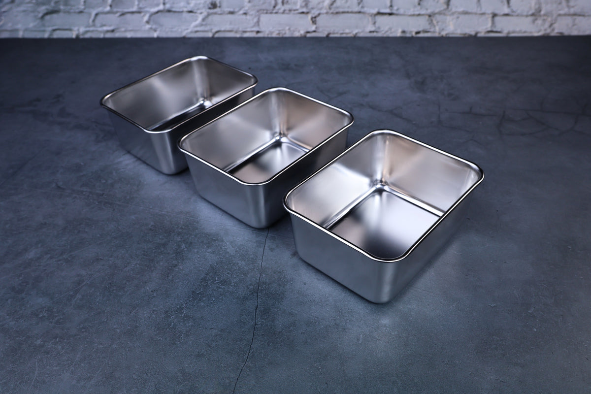 Yakumi 3-compartment condiment pan — three individual stainless steel inserts removed and displayed separately