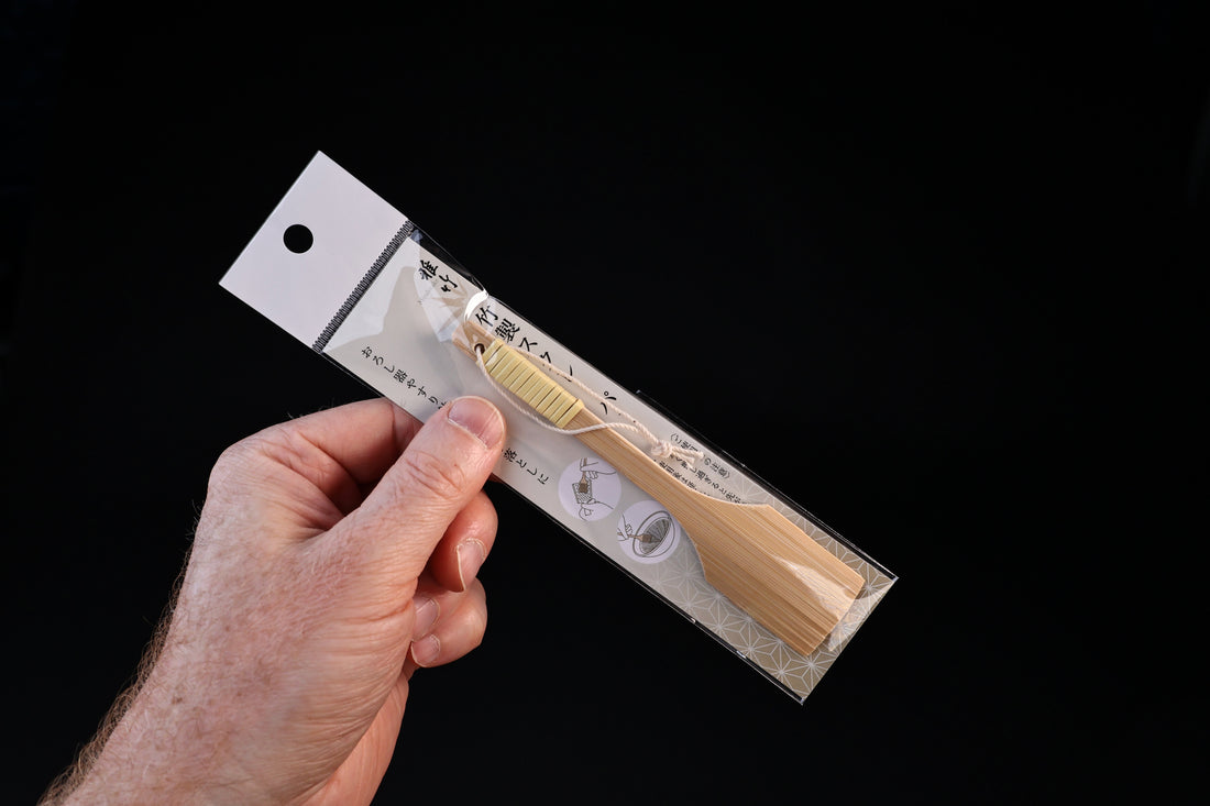 Yakumiyose bamboo brush 13cm — held in hand in packaging showing product scale against black background