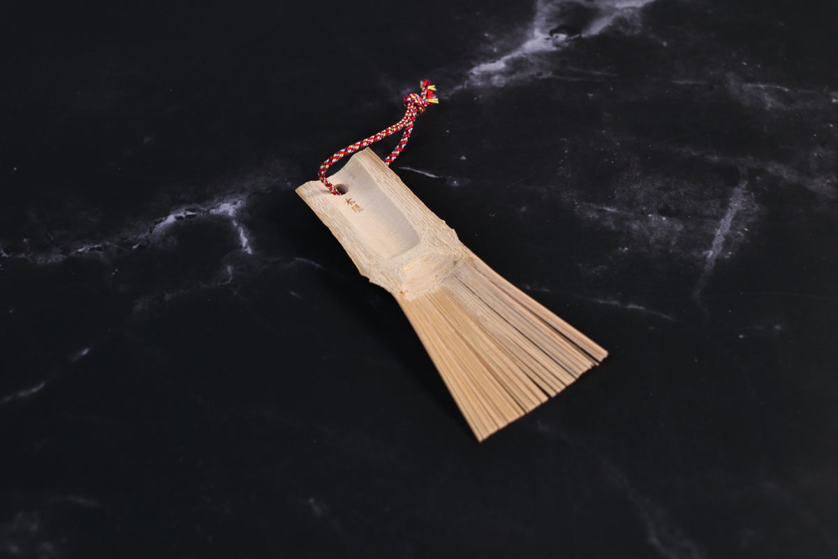 Yakumiyose bamboo brush showing the carved scoop in the handle and maker&