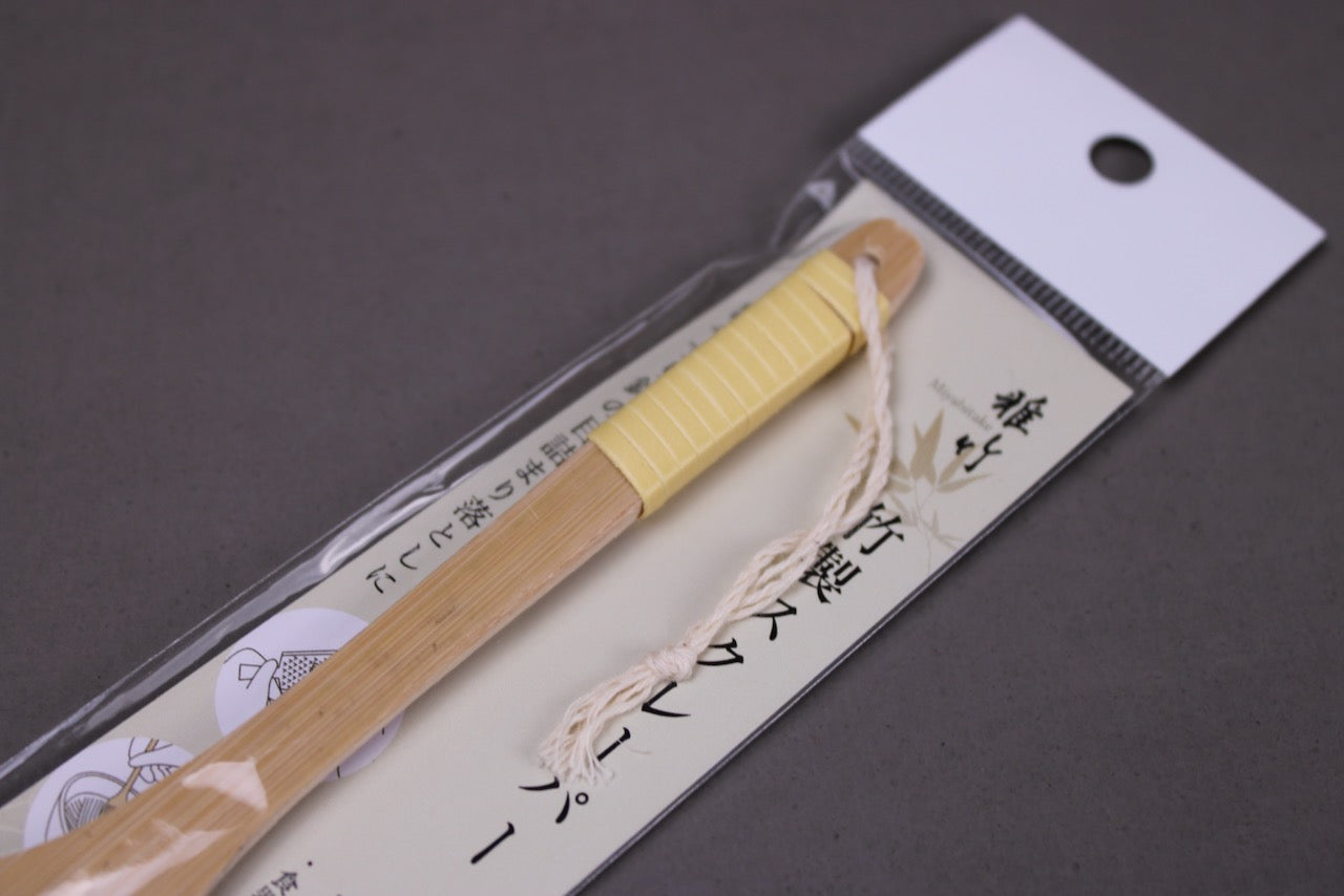 miyabitake brand made yakumiyose bamboo brush for grated condiments wrapped in packaging with hiragana closeup shot with grey background