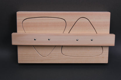 rectangular light tan hinoki wood onigiri maker two large triangles horizontal connecting wood nailed in place in dark backdrop