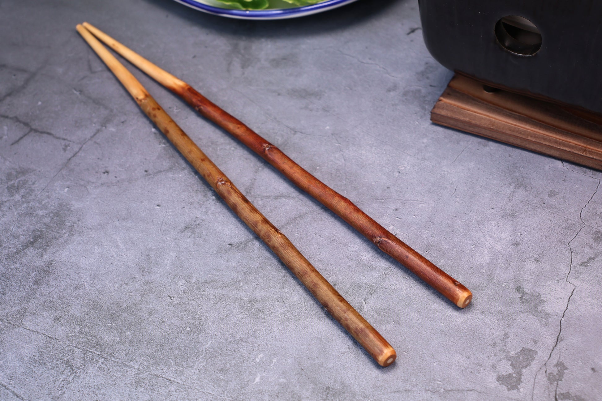 Yamacoh Plum Branch Saibashi Chopsticks 30cm — full profile on concrete surface with Japanese kitchen props