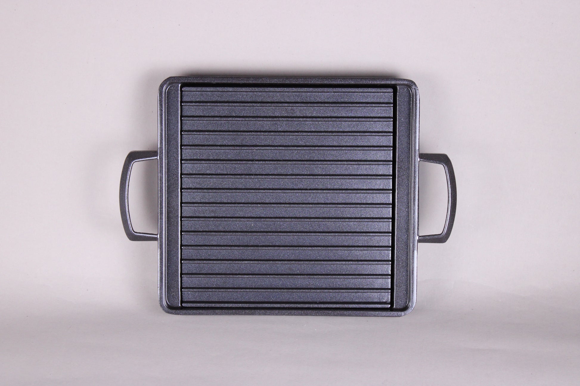 Yamacoh square grill — overhead view showing full ridged non-stick cooking surface and dual handles