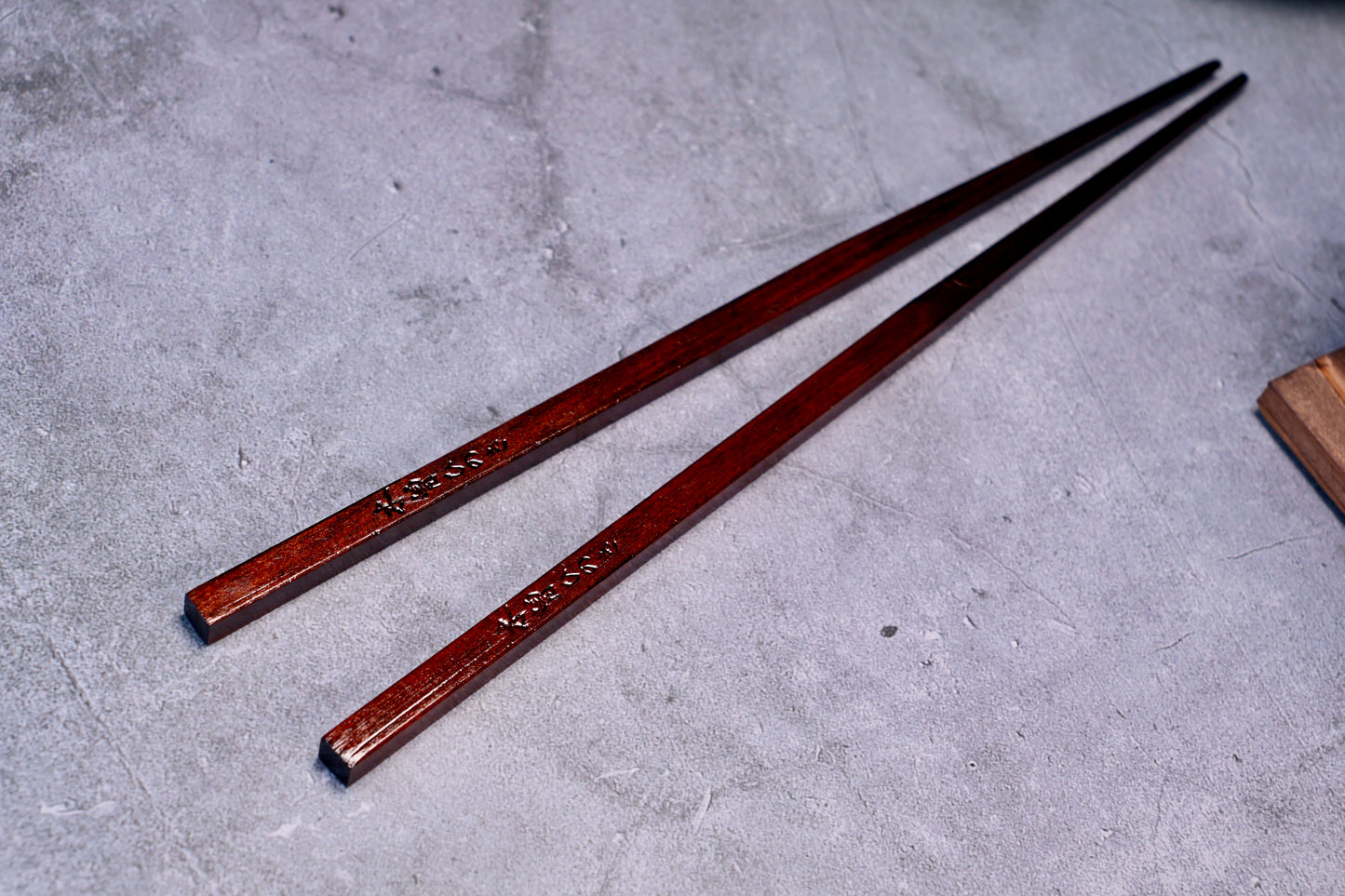 Yamacoh Suri Urushi Chopsticks Hinoki 22cm, full length pair with square ends prominent in foreground on concrete