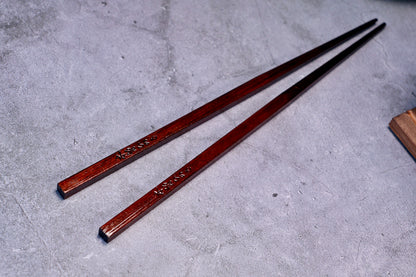 Yamacoh Suri Urushi Chopsticks Hinoki 22cm, full length pair with square ends prominent in foreground on concrete