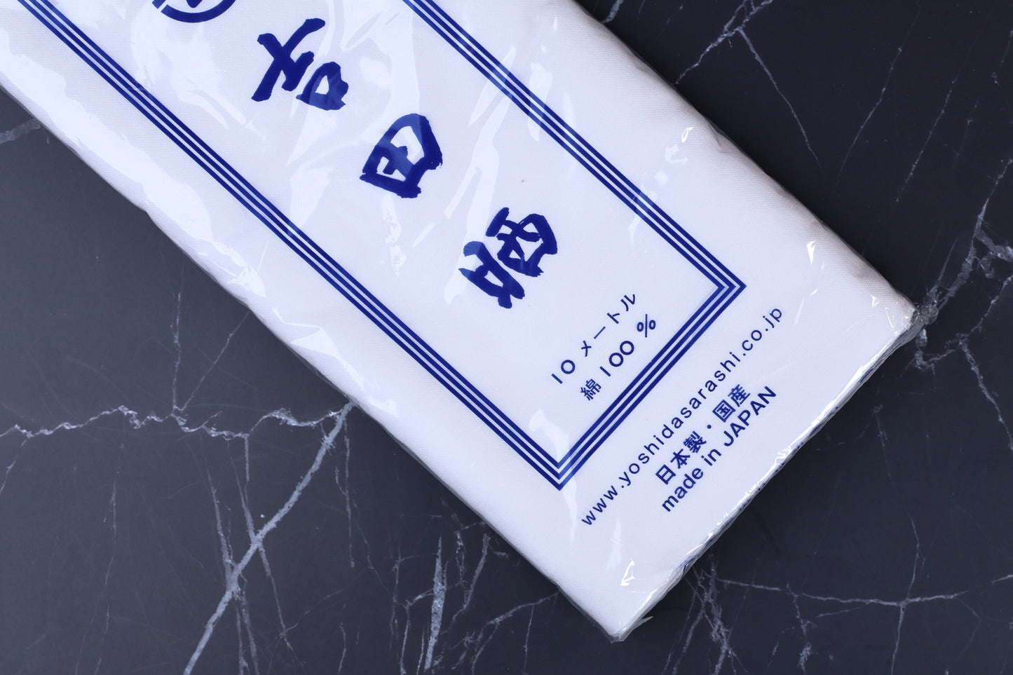 Yoshida Sarashi kitchen towel — close-up of packaging label showing Made in Japan and 100% cotton details
