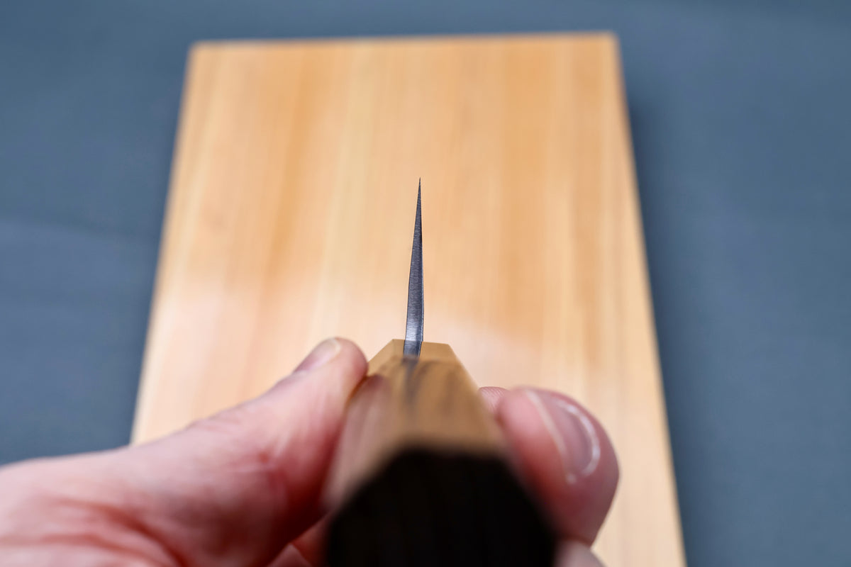 Yoshikane SKD Tsuchime Gyuto 210mm blade tip viewed straight down the cutting edge showing ultra-thin profile