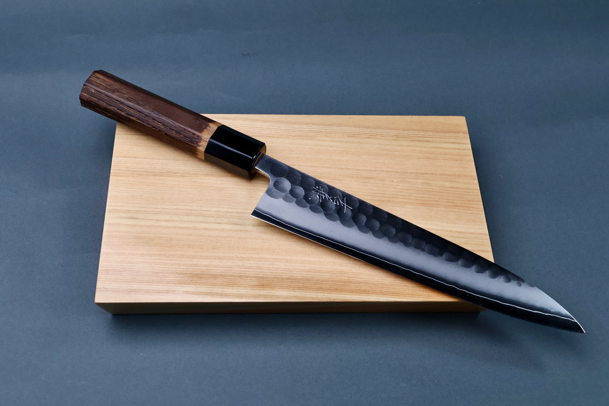 Yoshikane SKD Tsuchime Gyuto 210mm full profile flat on grey background showing complete blade and burnt chestnut handle