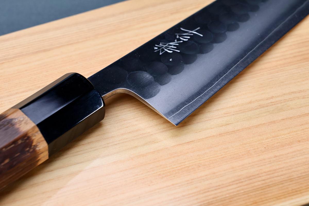 Yoshikane SKD Tsuchime Gyuto 210mm heel and choil on hinoki board showing kanji engraving and buffalo horn collar