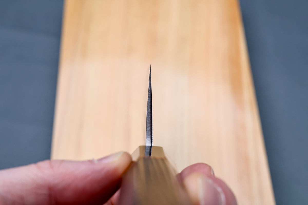 Yoshikane SKD Tsuchime Nakiri 165mm blade tip viewed straight down the cutting edge showing ultra-thin profile