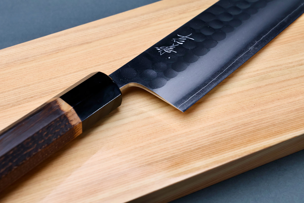 Yoshikane SKD Tsuchime Nakiri 165mm heel and choil detail on hinoki board showing kanji engraving and buffalo horn collar