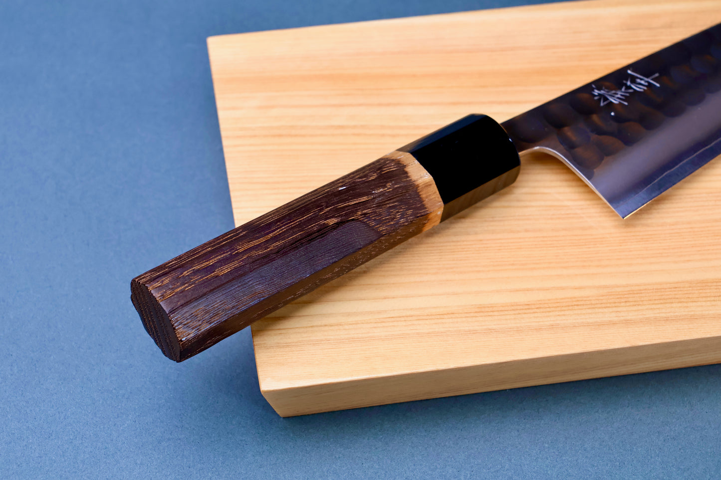 Yoshikane SKD Tsuchime Santoku 165mm burnt chestnut octagonal handle and buffalo horn collar on hinoki board