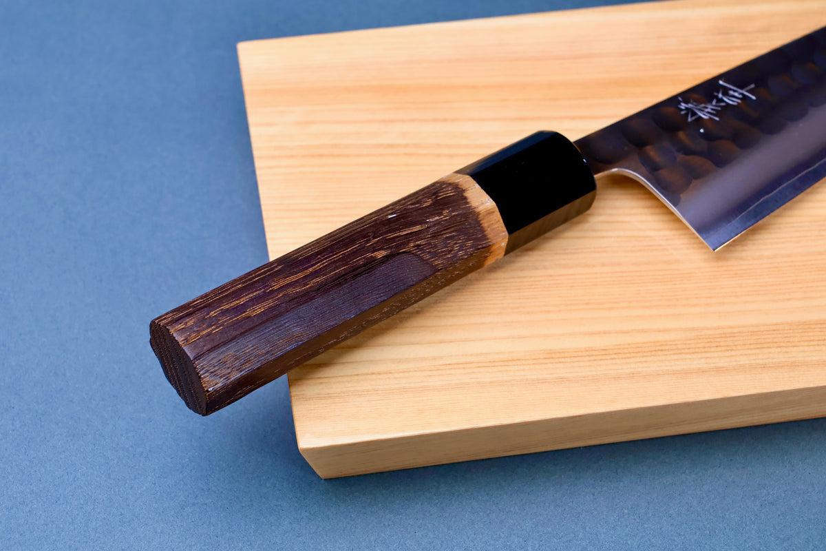 Yoshikane SKD Tsuchime Santoku 165mm burnt chestnut octagonal handle and buffalo horn collar on hinoki board