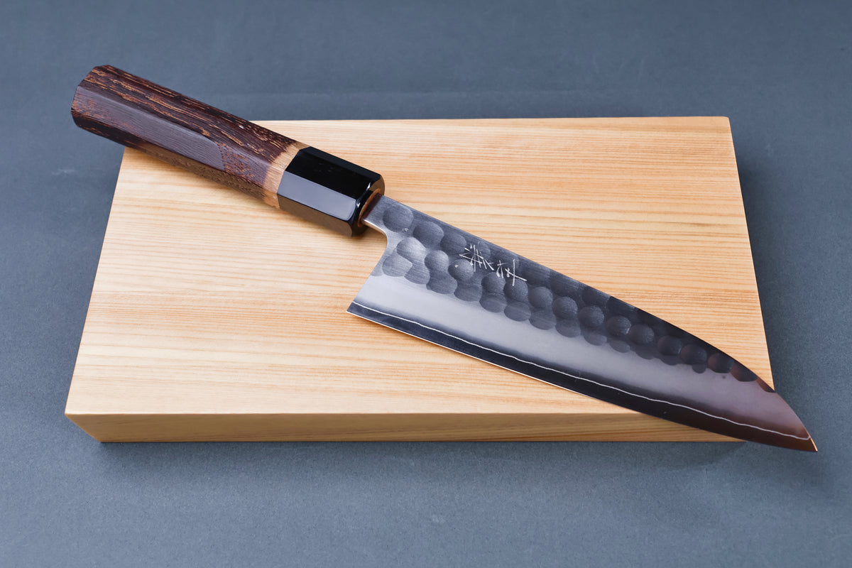 Yoshikane SKD Tsuchime Santoku 165mm resting on hinoki cutting board showing complete knife profile