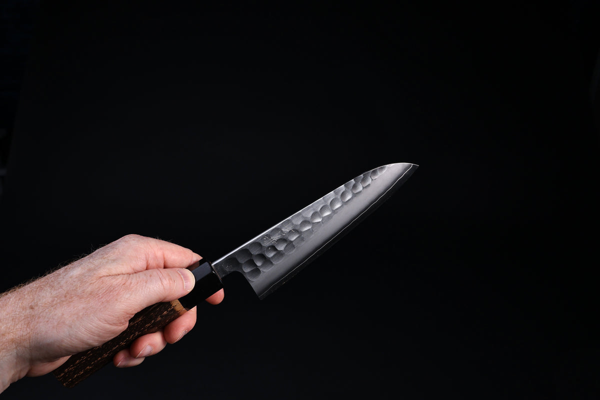 Tsuchime hammered finish detail on Yoshikane SKD Santoku 165mm blade face