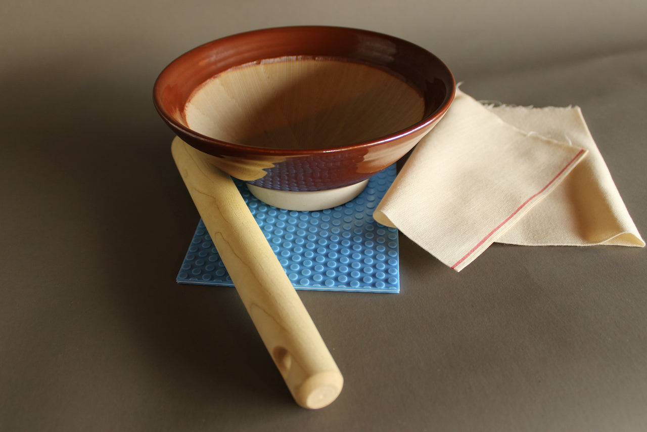 kiya cotton cloth beside suribachi bowl and pestle atop hasegawa nonslip mat colored bright blue with grey background